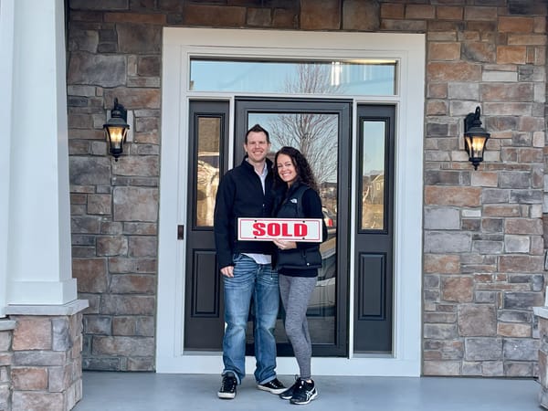 Dave & Amy infront of their new home. 